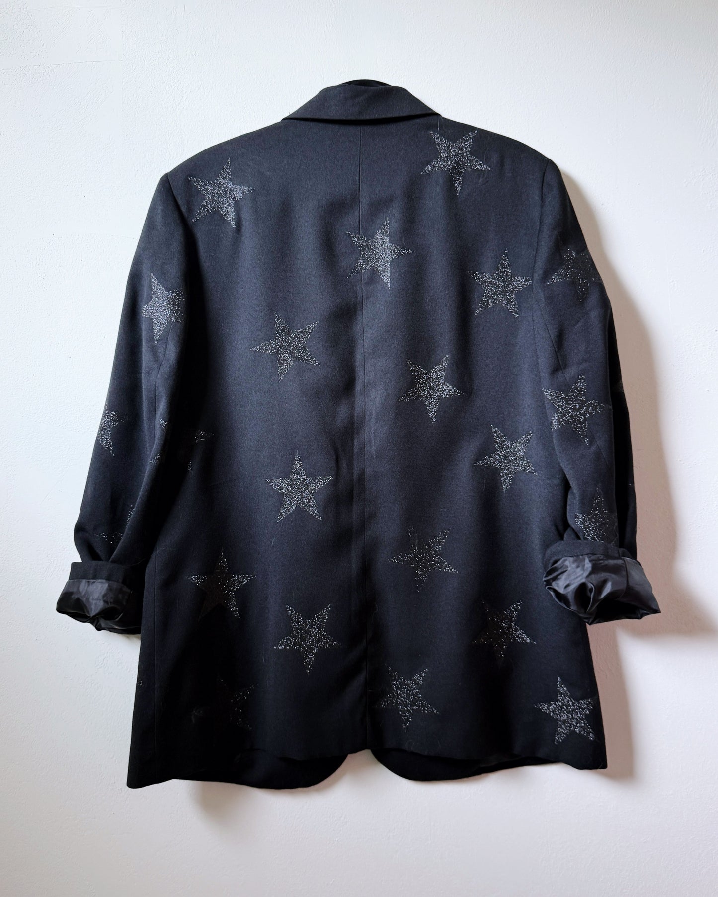 Black shirt with star patterns on a white background