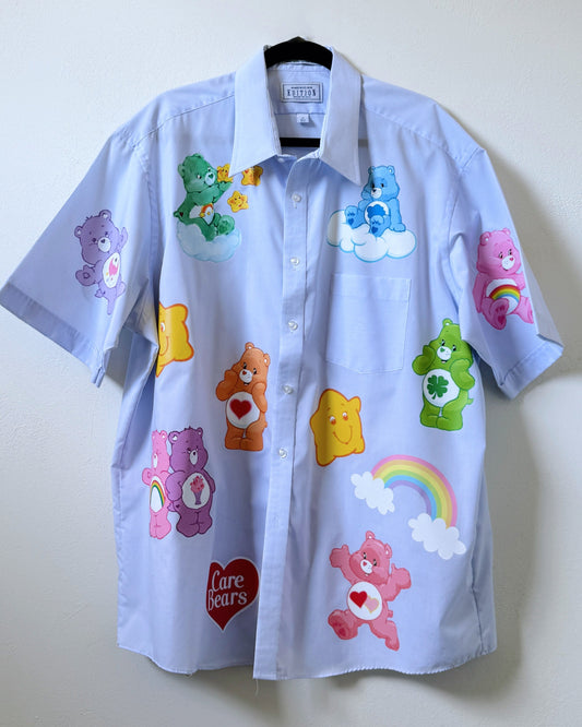 A light blue button-up shirt with various Care Bear designs ironed on the front.