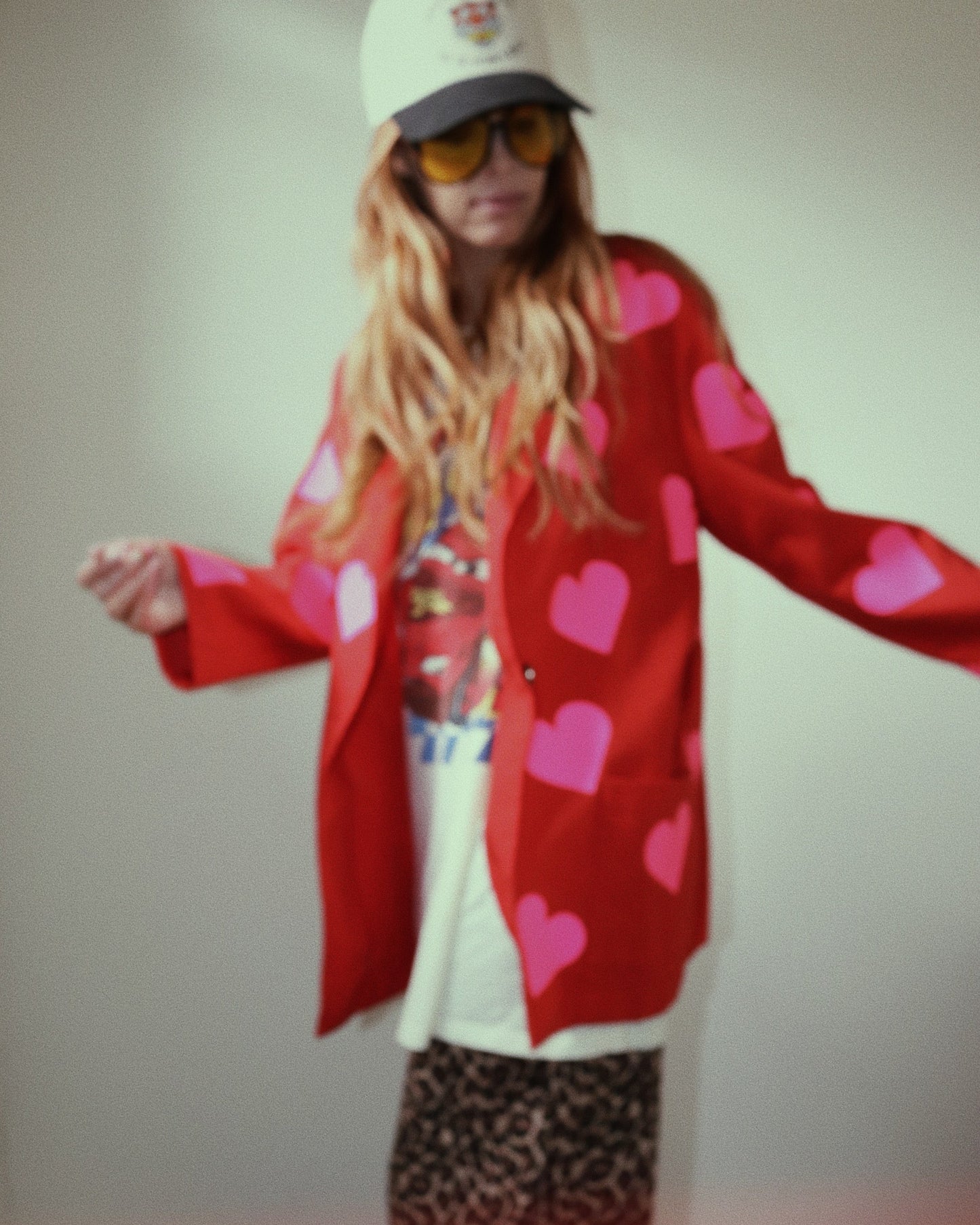 Model wearing upcycled red blazer with neon pink hearts, front view, styled outfit, statement jacket. Lightweight red blazer