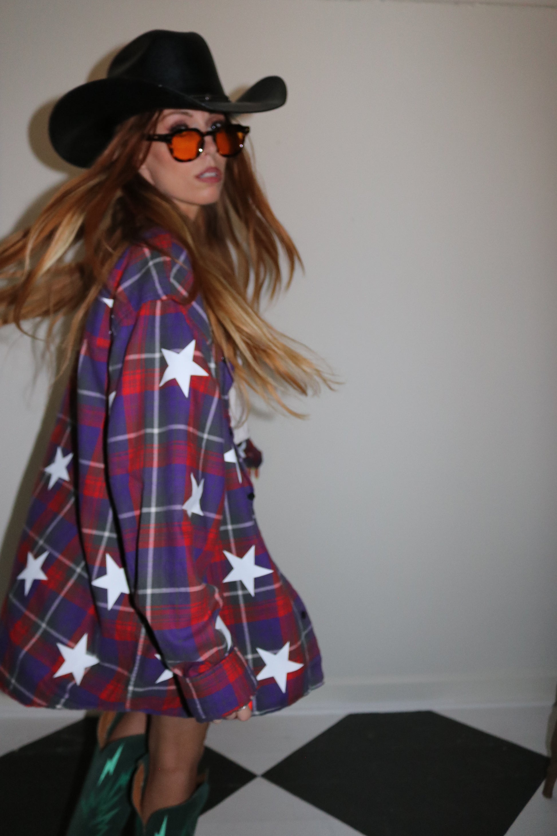 Person wearing a red, white, and blue plaid outfit with star patterns.
