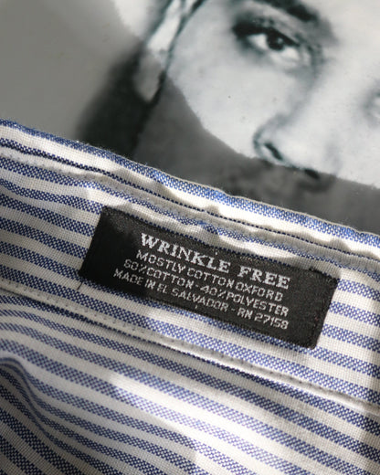 Close-up of a wrinkle-free label on a striped shirt with a blurred portrait in the background.