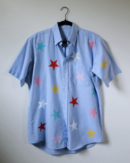 Light blue shirt with colorful star patterns on a white background