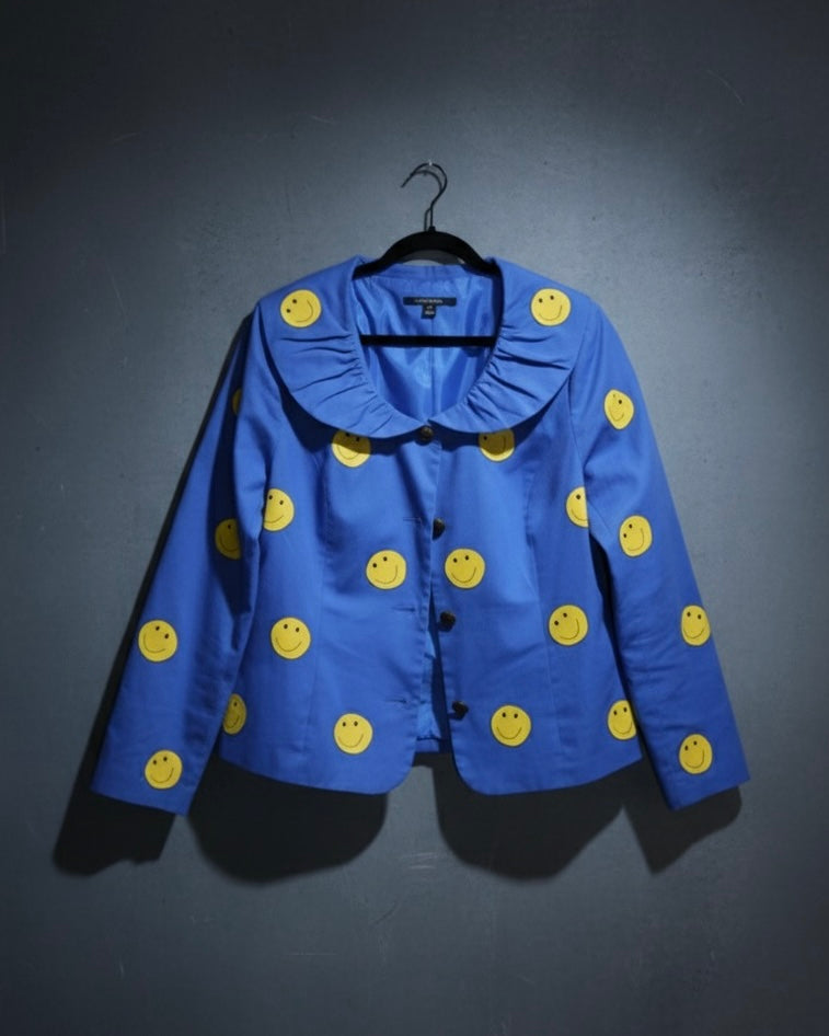 Blue jacket with yellow smiley face patterns on a dark background