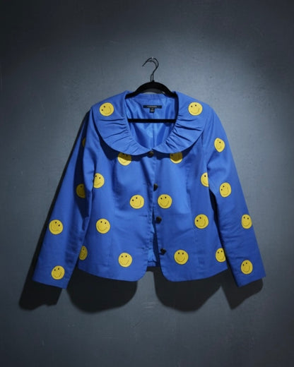 Blue jacket with yellow smiley face patterns on a dark background