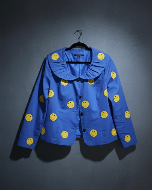 Blue jacket with yellow smiley face patterns on a dark background