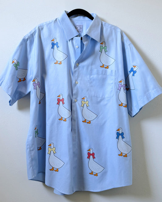 A light blue button-up shirt with embroidered vinyl goose designs